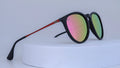 Sunglasses with pink and green gradient lenses on a white background