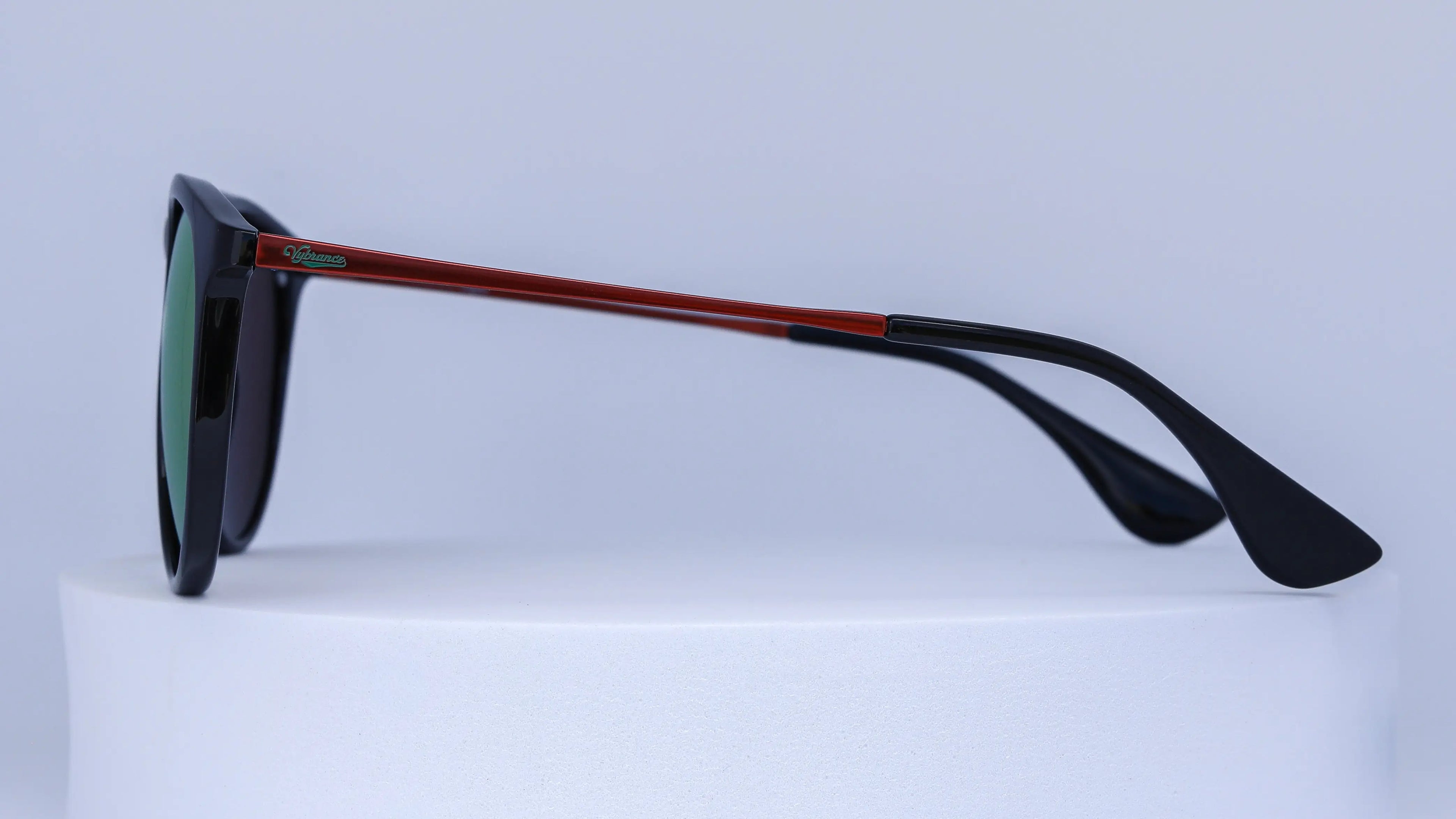 Sunglasses with black frame and red accents on a white background