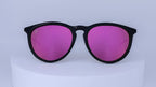 Sunglasses with black frames and pink lenses on a white background