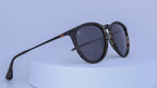 Sunglasses with tortoiseshell patterned frame on a white background