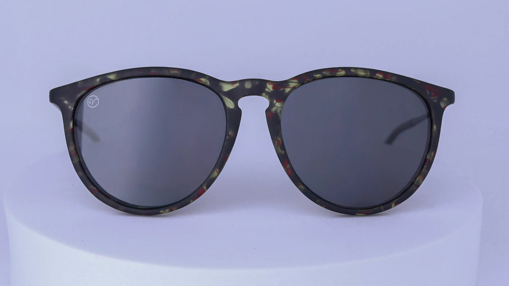 Sunglasses with tortoiseshell patterned frame on a white background
