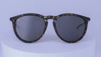 Sunglasses with tortoiseshell patterned frame on a white background