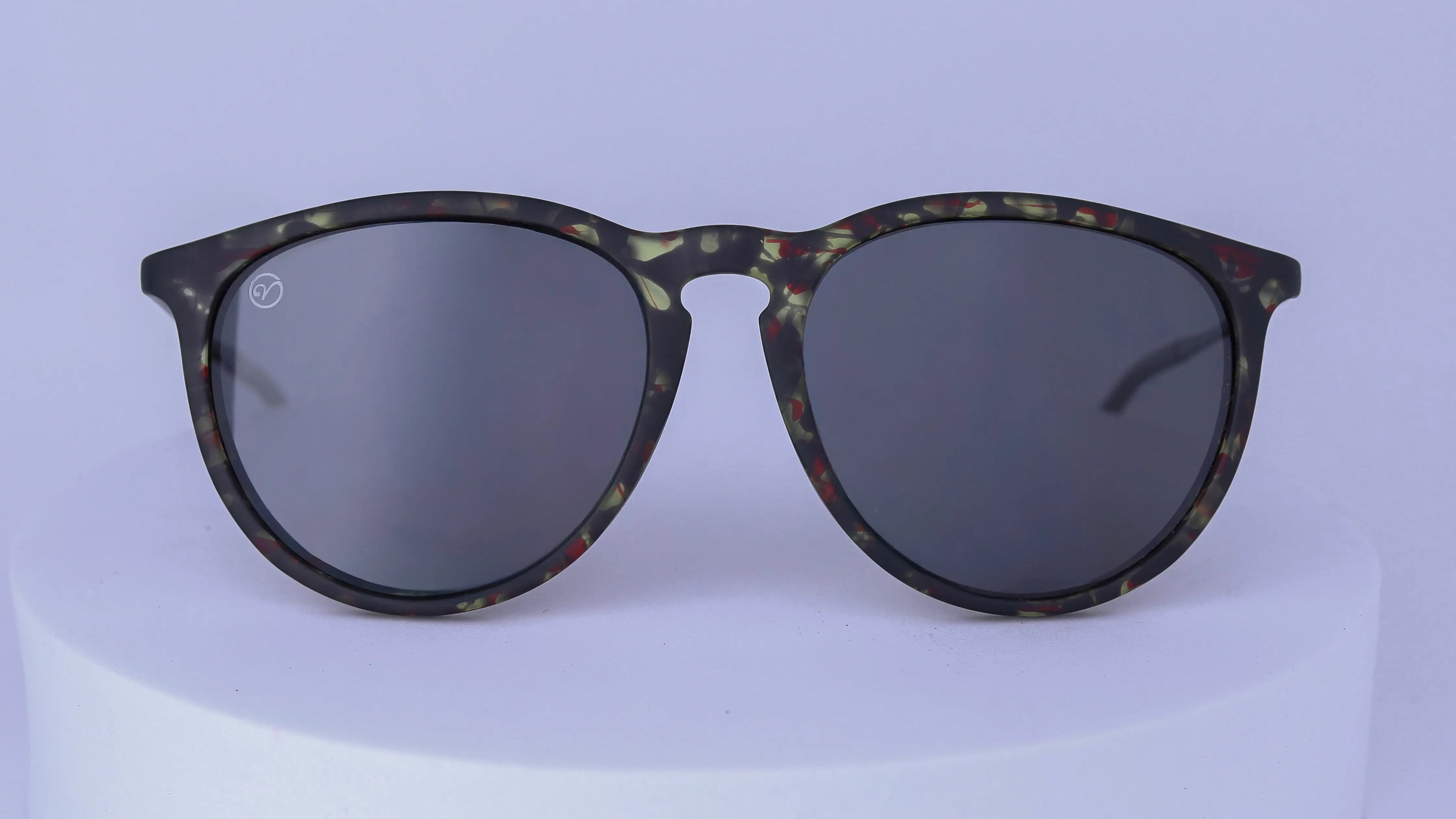 Sunglasses with tortoiseshell patterned frame on a white background