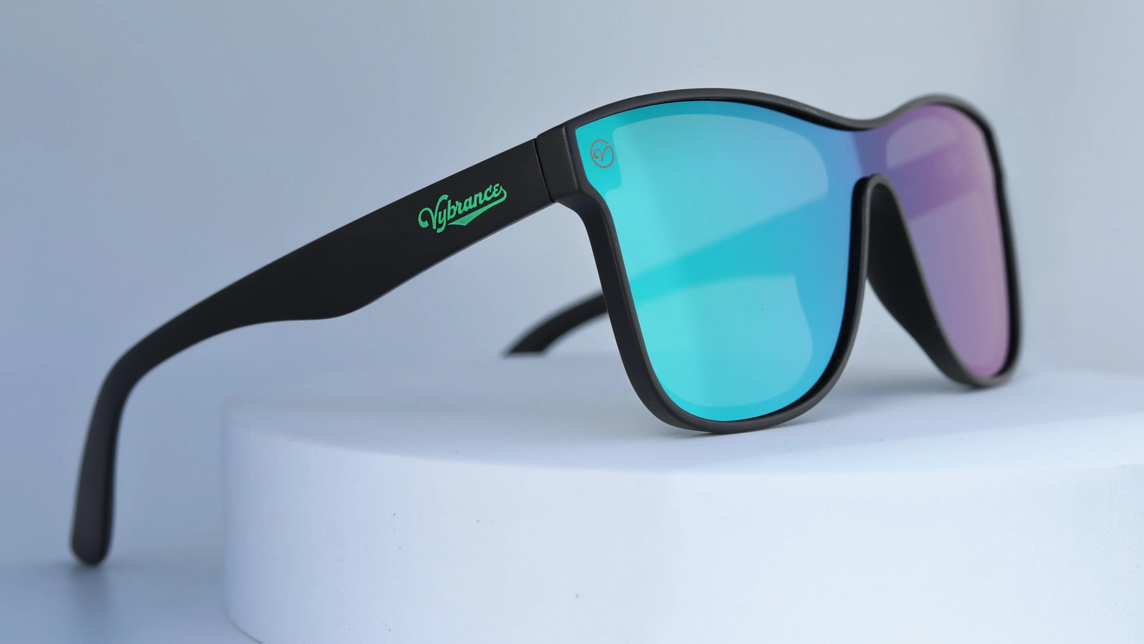 Sunglasses with black frame and multicolored lenses on a white background