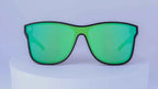 Green sunglasses on a white pedestal with a white background