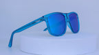 Blue sunglasses on a white pedestal against a white background