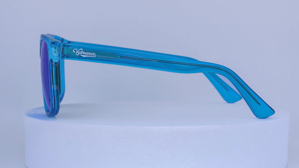 Blue sunglasses with a visible Vybrance logo on a white background