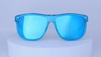 Blue sunglasses on a white pedestal against a white background